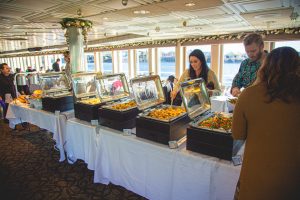 Portland Spirit | Columbia Deck | Buffet People going through buffett with windows behind them