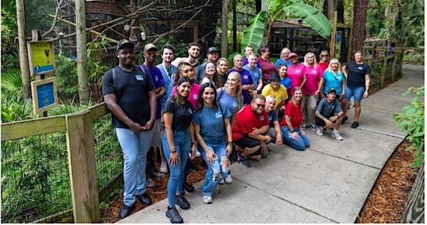 Group of people posing on walk way for botanical habitat